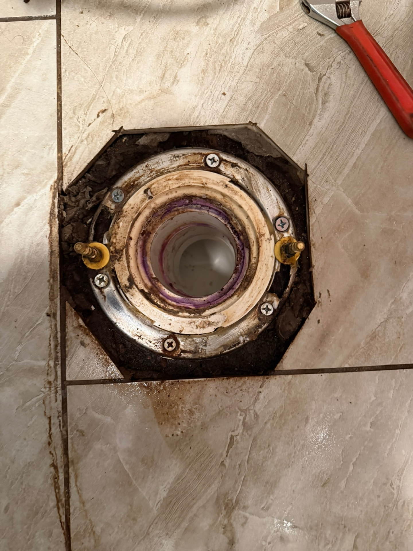 Exposed toilet flange area being inspected, prepared and secured by Drain Wizard Plumbing in Connecticut