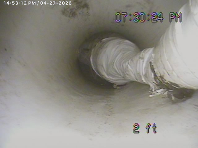 PipePatch spot repair installed at 2 ft: fiberglass sleeve fused to the host pipe, sealing a cracked joint without digging up the yard. Trenchless, permanent.