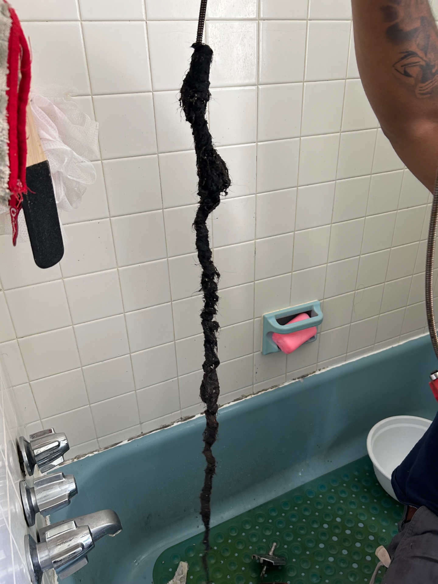 Same tub drain clog, fully removed from the line. This is why mechanical cleaning beats chemicals every time.