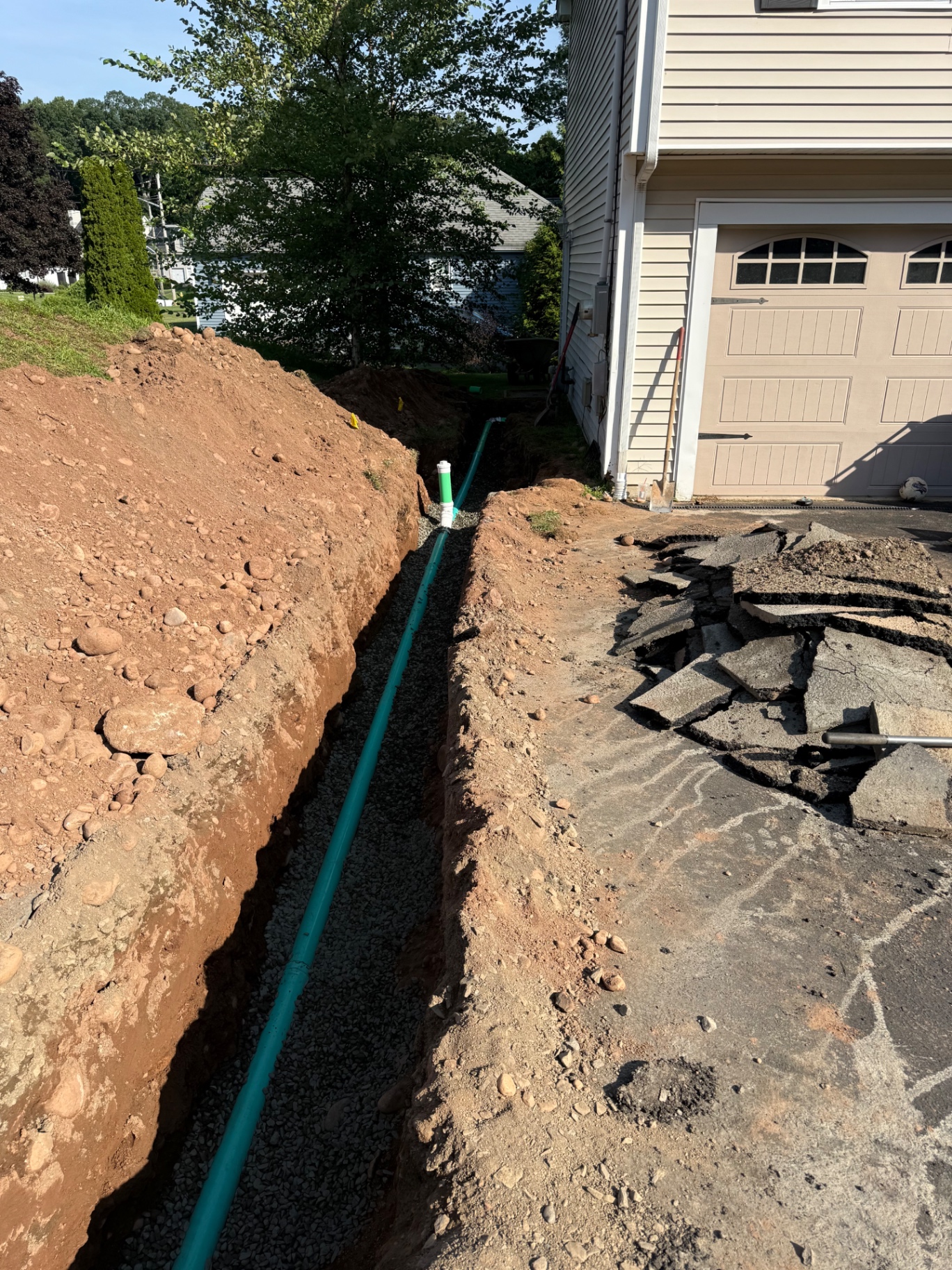 Exterior trench with new underground piping installed beside a Hamden home