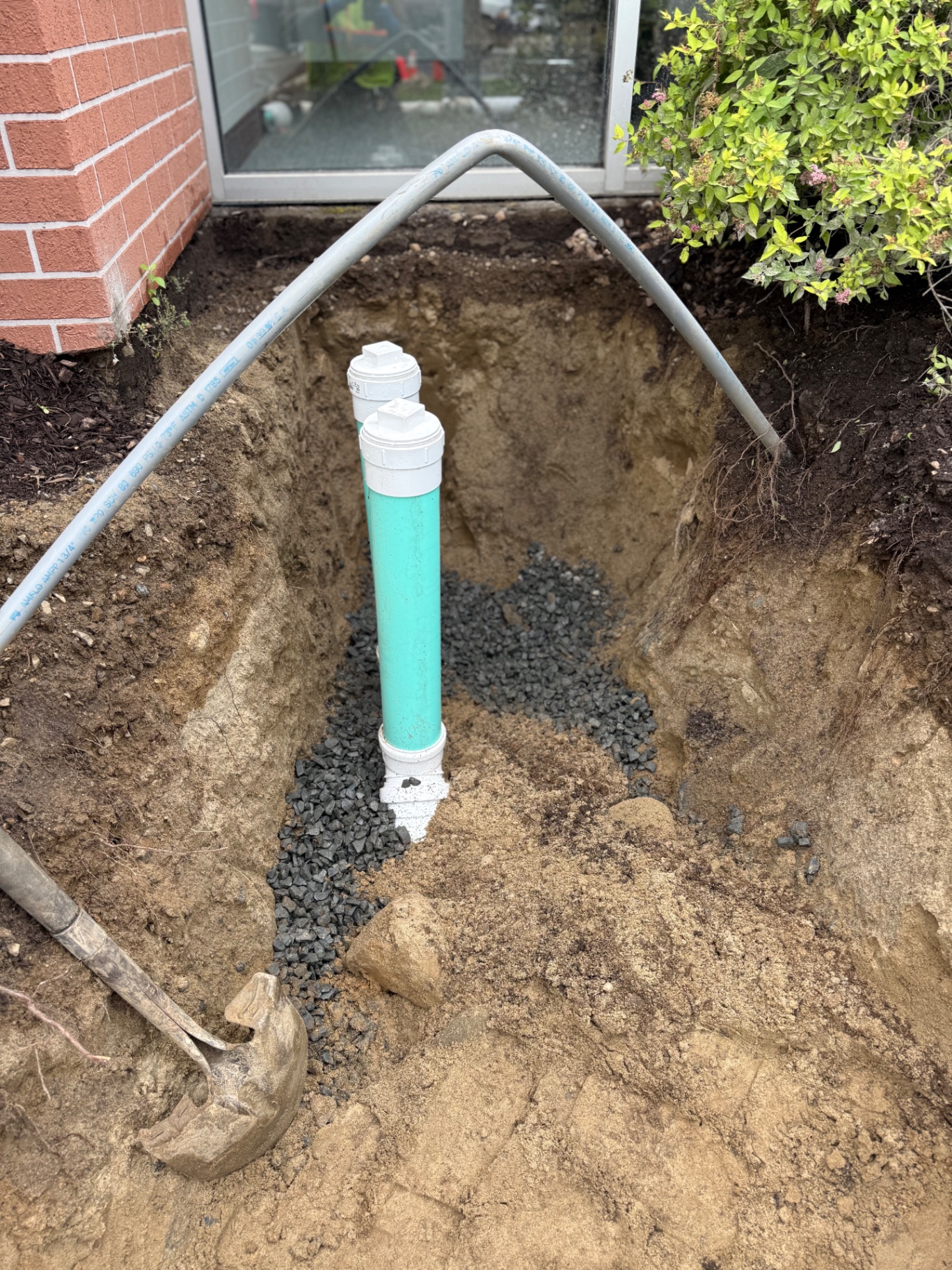 Two-way cleanout risers installed at the building — cleanouts on 3/4" stone give future service techs (us or anyone else) easy access to camera and jet the line.