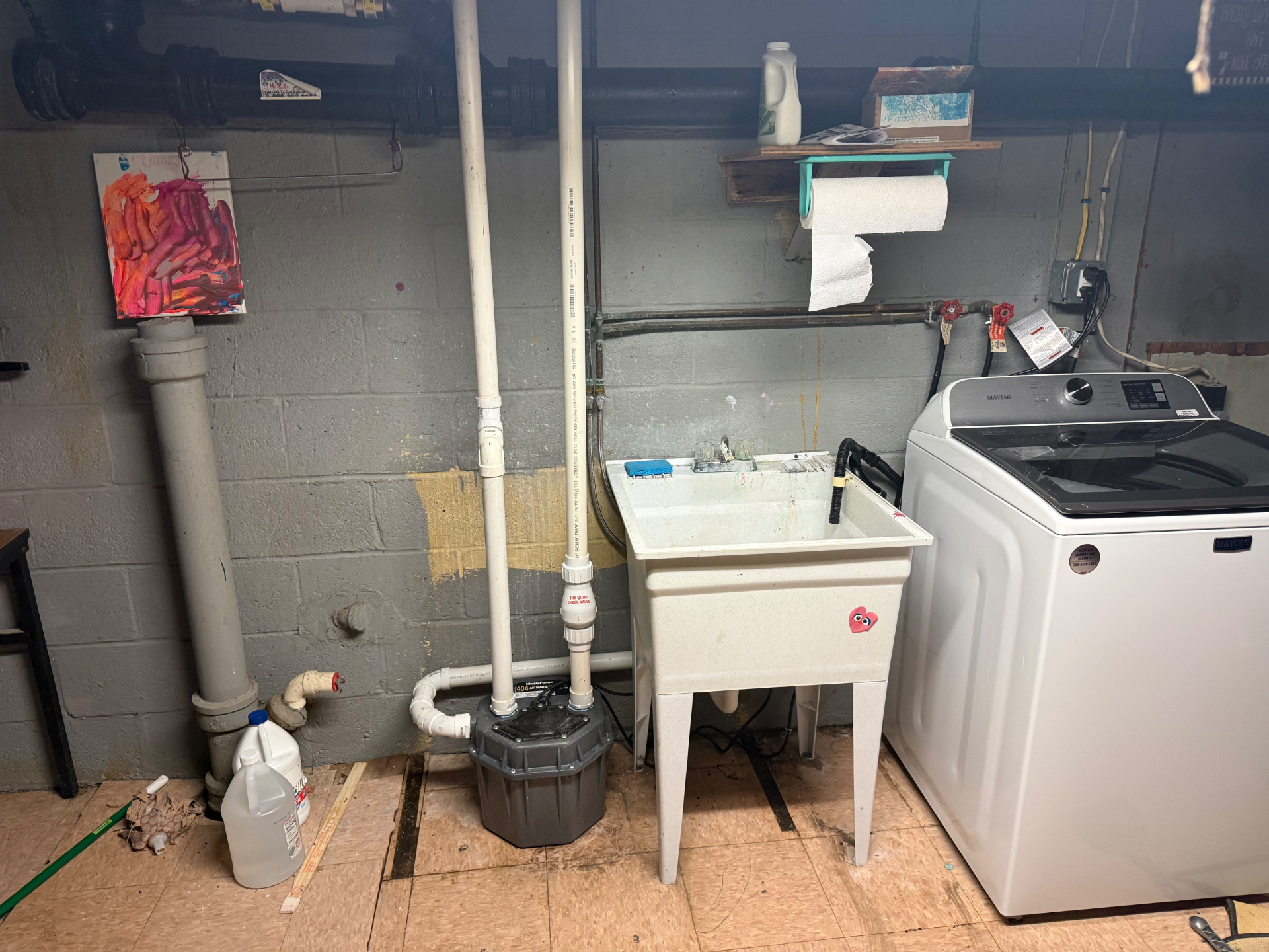Laundry pump and utility sink installation in a Connecticut basement — a sealed, automatic pump system handles the laundry sink and washing machine discharge when the drain is below the main line.