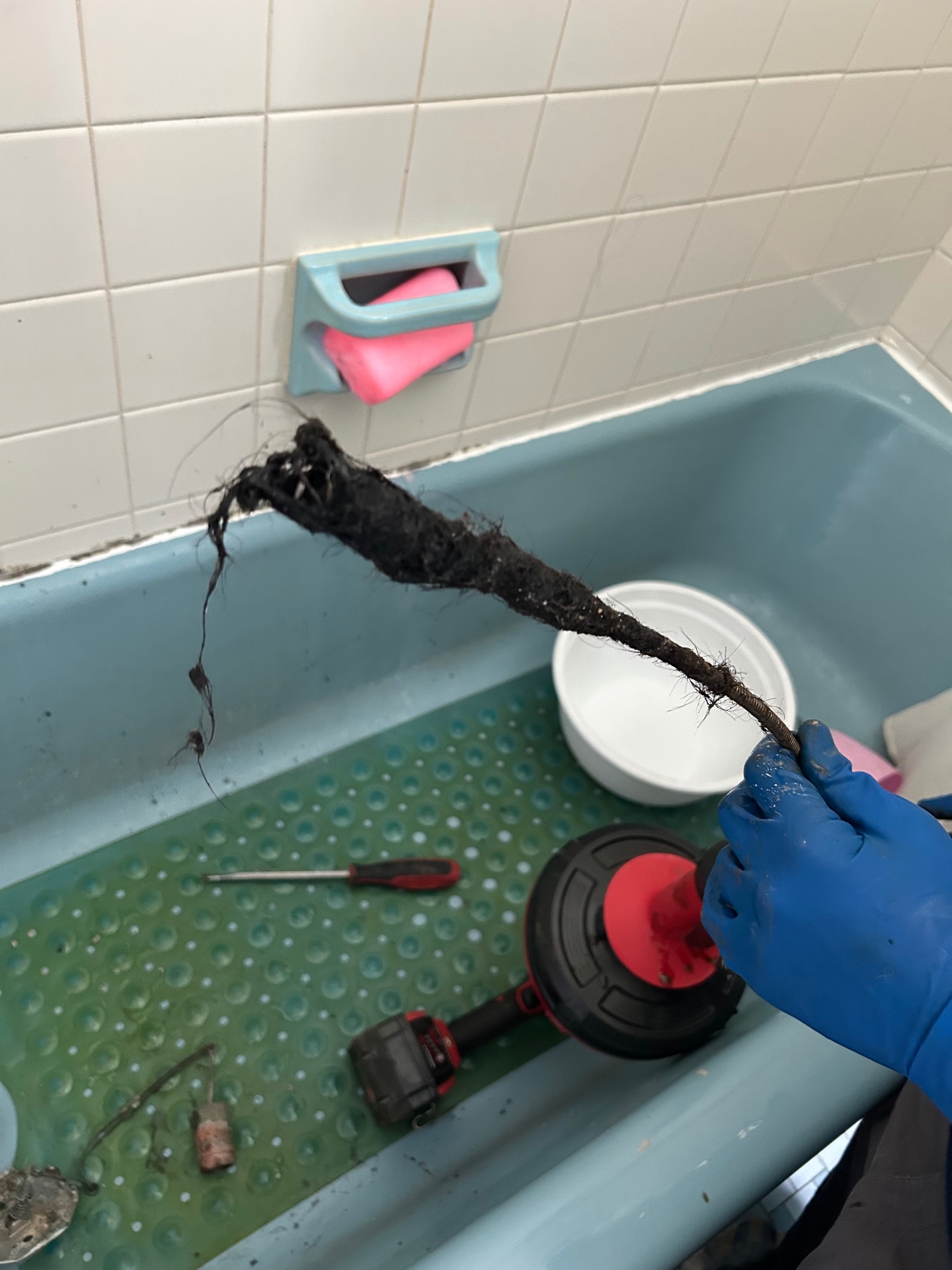Corey pulling a massive hair and soap clog from a Connecticut tub drain — the kind of buildup that no amount of store-bought drain cleaner will touch.