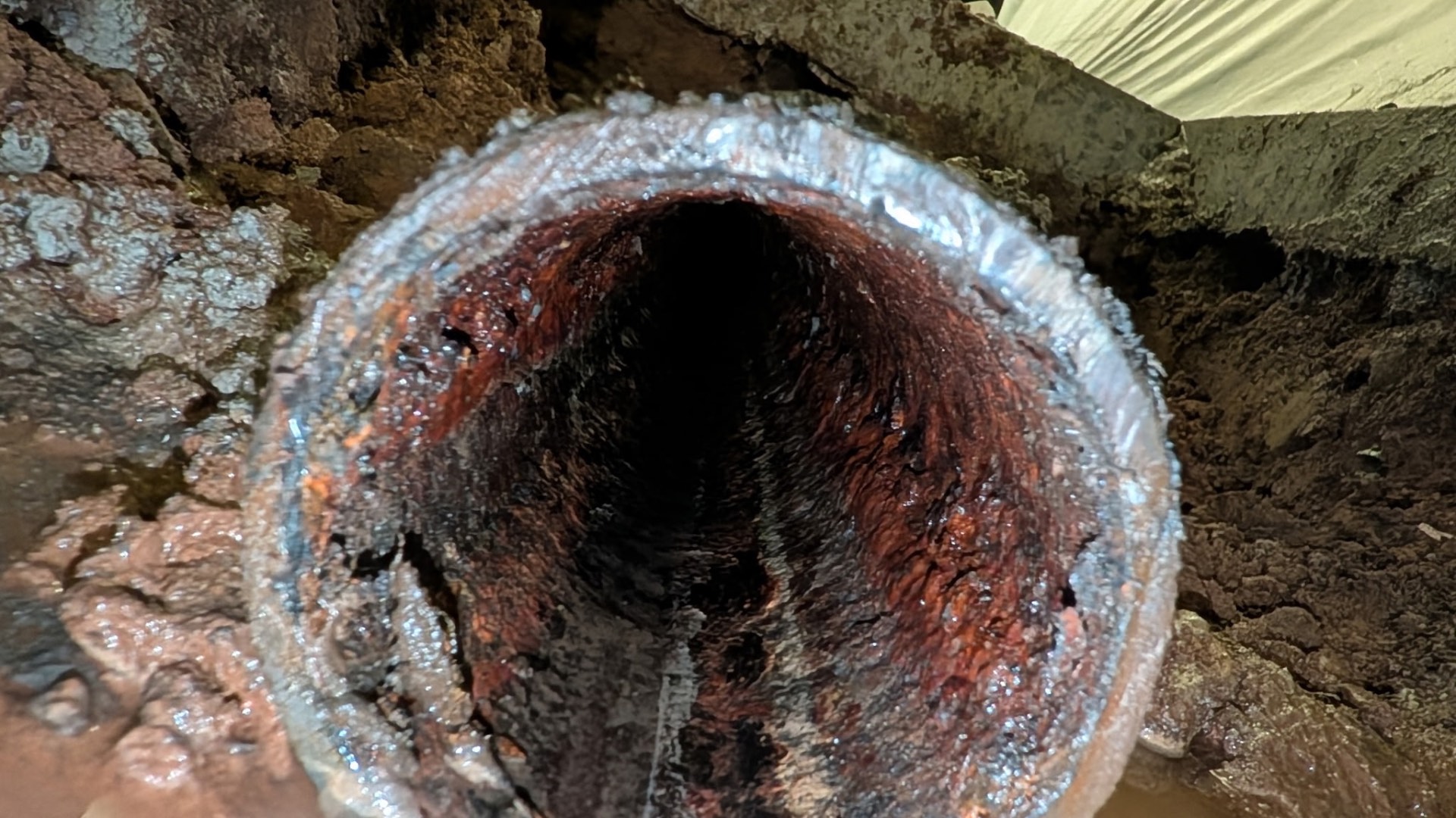 Interior view of the old line: heavy scale, corrosion, and reduced flow. No amount of cabling or jetting brings a pipe in this condition back.