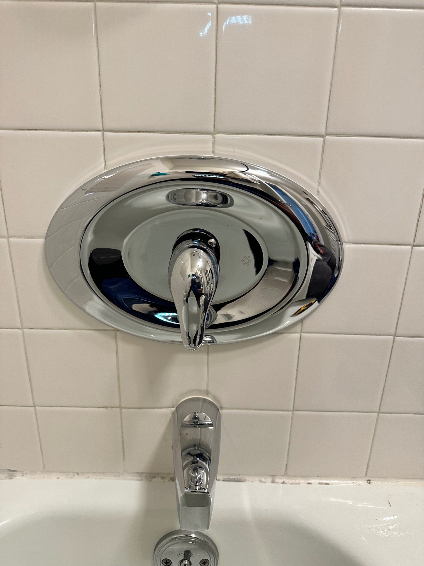 Chrome bathtub faucet and shower control installed on a tiled Wallingford wall